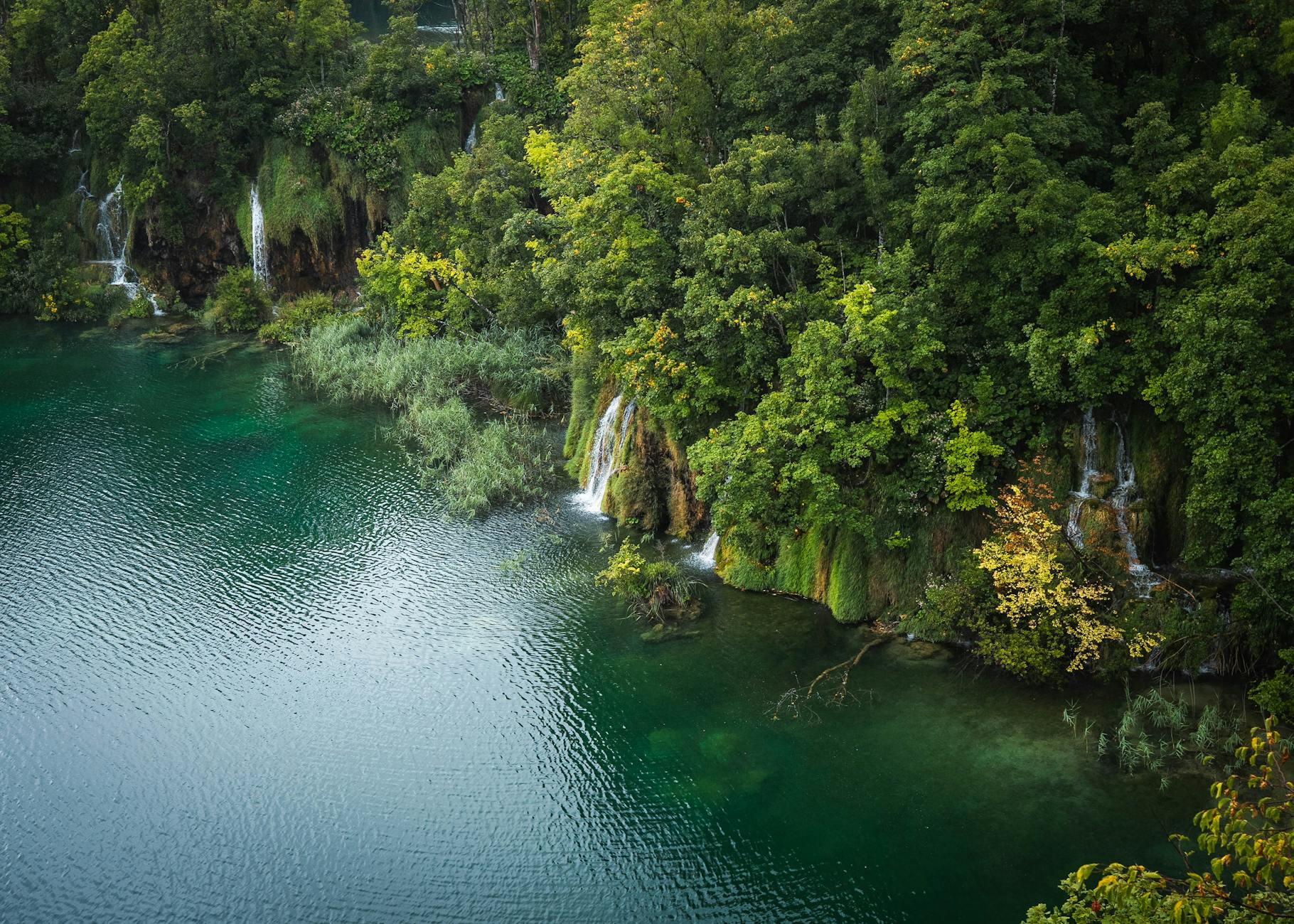 Aerial view of lush waterfalls and turquoise waters in Plitvice Lakes, Croatia. (Photo: Sven Huls / Pexels)