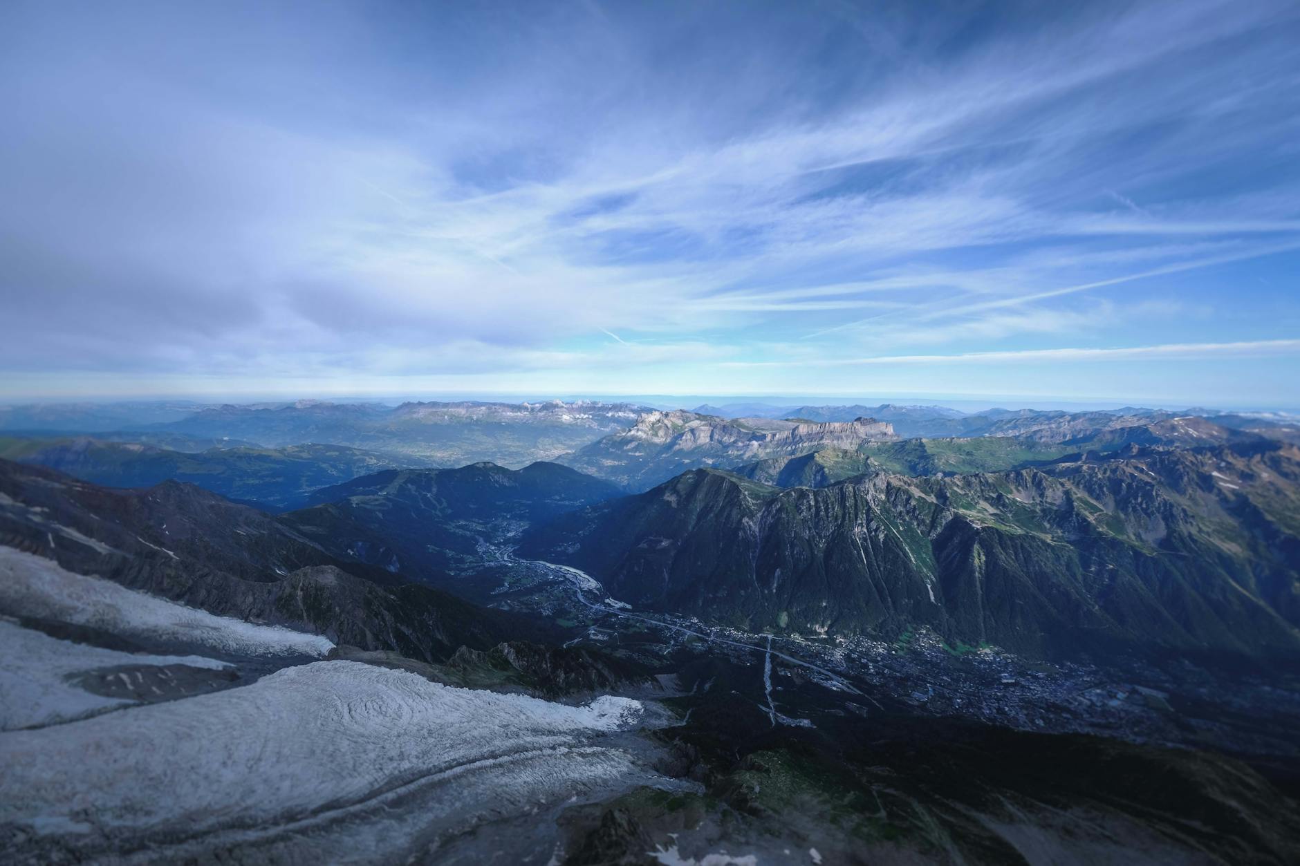 A stunning aerial view of the mountain ranges and valleys in Chamonix, France, under a clear sky. (Photo: Francesco Ungaro / Pexels)