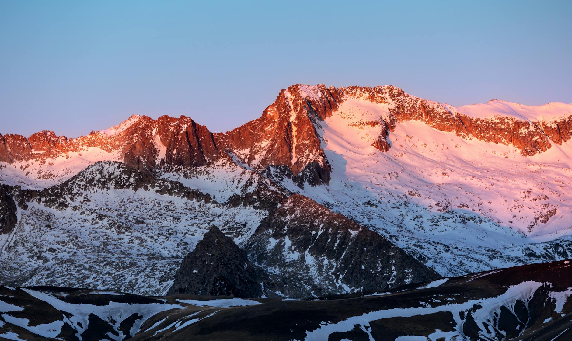 Breathtaking view of the snow-capped Pyrenees during sunset in Benasque, Spain.